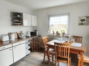 a kitchen with a wooden table and a dining room at FeWo Sartorius am Hemsberg in Bensheim