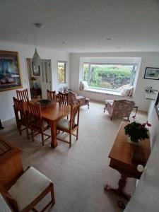 a living room with a wooden table and chairs at Modern Home in Central Location in New Plymouth