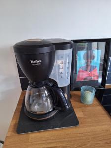 a coffee maker on a counter next to a microwave at Appartement Indépendant à Terrerort in Saumur +2 photos