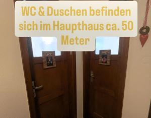 two wooden doors with a sign that reads we and chicken kitchen sign im hogwarts at Klosterweiherhof in Dachsberg im Schwarzwald
