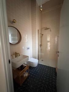 a bathroom with a sink and a toilet and a shower at Le Couvent in Lunac +32 photos