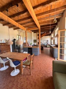 a kitchen and dining room with a wooden table and chairs at Le Couvent in Lunac