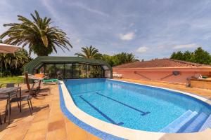 a swimming pool in front of a house at Basque Palace, Mansion con Jardín, Barbacoa, Gimnasio, Piscina, Sauna in Mungia