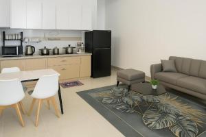 a living room with a couch and a table and a kitchen at Napoleon Apartment Nha Trang - Gần Biển Hòn Chồng in Nha Trang +12 photos