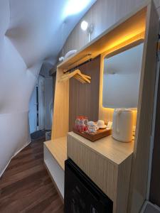 a kitchen with a counter with a mirror and a sink at Nualam Glamping in Pasirangin