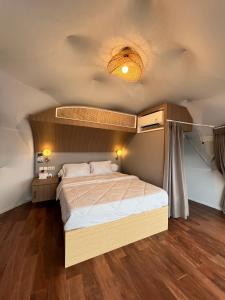 a bedroom with a large bed in a room at Nualam Glamping in Pasirangin +14 photos