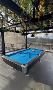 a pool table in a pavilion with a blue at Nualam Glamping in Pasirangin