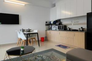a living room with a kitchen and a table at Napoleon Apartment Nha Trang - Gần Biển Hòn Chồng in Nha Trang