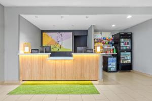 a lobby of a store with a counter and a refrigerator at Spark by Hilton Terrell in Terrell