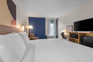 a hotel room with a large bed and a flat screen tv at Spark by Hilton Terrell in Terrell +35 photos