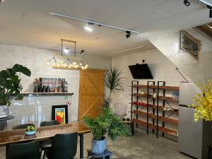 a dining room with a table and a refrigerator at 旅人路過時民宿 in Hsi-lo
