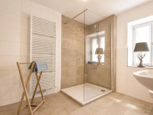 a bathroom with a shower and a sink at Guade Stub'n Franzi in Huglfing +11 photos