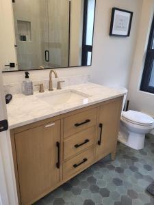 a bathroom with a sink and a toilet at Modern condo with town and mountain views in Evergreen +8 photos