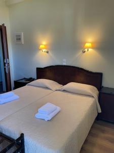a bedroom with two white towels on a bed at Hotel Karthea in Korissia +53 photos