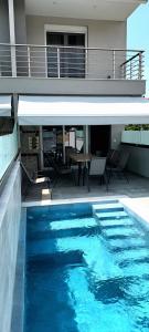 a swimming pool in front of a house at Twins house pool 2 in Nikiti