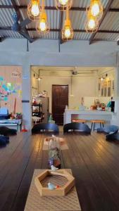 a room with a wooden floor with a table in it at Pirate's Cove in Malacca