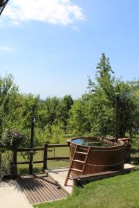 a hot tub in a garden next to a fence at Javor Holiday House in Žumberak