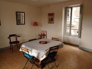 a room with a table and chairs and a window at 2-room apartment in Clamecy