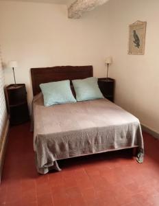 a bedroom with a bed with two pillows on it at 2-room apartment in Clamecy