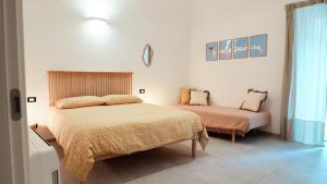 a bedroom with two beds in a room at La Terrazza di Maddalena in Cisano sul Neva