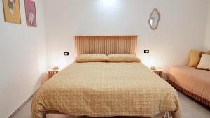 a bedroom with a bed with a yellow bedspread at La Terrazza di Maddalena in Cisano sul Neva +56 photos