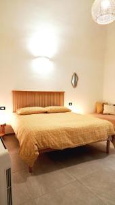 a bedroom with a large bed in a room at La Terrazza di Maddalena in Cisano sul Neva