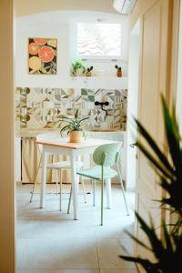 a dining room with a white table and chairs at La Terrazza di Maddalena in Cisano sul Neva
