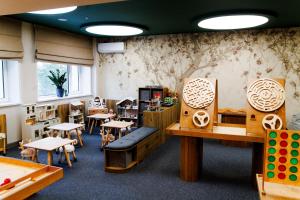 a classroom with desks and tables and chairs at Altay Resort in Shchūchīnsk