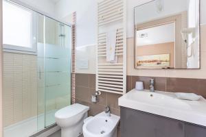 a bathroom with a toilet and a sink and a mirror at B&B Acquamarina in Gallipoli