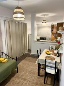 a kitchen and dining room with a table and chairs at Azure & Zest Suites in Ierissos