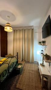 a bedroom with a bed and a table and a television at Azure & Zest Suites in Ierissos