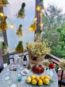 a table with fruit and a basket of flowers on it at Azure & Zest Suites in Ierissos +20 photos