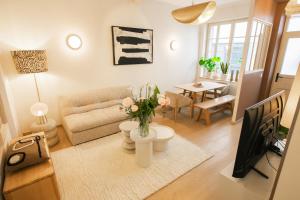 a living room with a couch and a table at Maison Lumière Arras in Arras