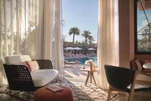 a living room with a view of a pool at Royal Mansour Marrakech in Marrakech