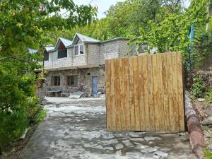 a wooden gate in front of a house at Адами драхт in Garni