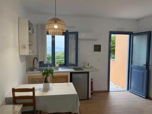 a kitchen and dining room with a table and a table and chairs at Taxiarchis in Symi +32 photos