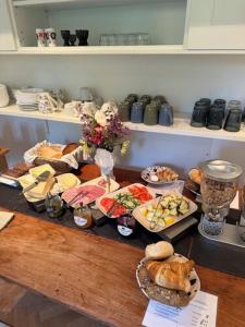 a table with many different types of food on it at Minnesberg Bed & Breakfast in Trelleborg