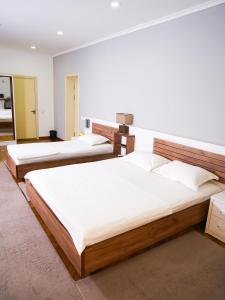 a group of three beds in a room at ECO ART Hotel in Tashkent