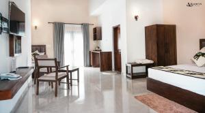a bedroom with a bed and a desk and chairs at Velowyn Ella in Ella