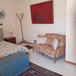 a living room with a couch and a bed at Orchard House South Room in Pergola