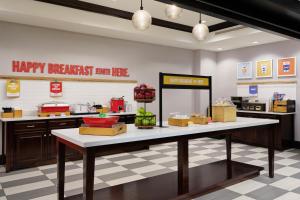a kitchen with a table with food on it at Hampton Inn Thomson in Thomson