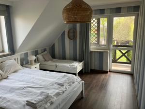a bedroom with a white bed and a window at Dom Nowe Krzywe in Nowe Krzywe +17 photos