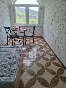 a room with a table and chairs and a table and a window at Адами драхт in Garni