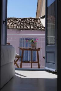 a small table with a potted plant on it at BOĒM Boutique Hotel Lefkada in Lefkada