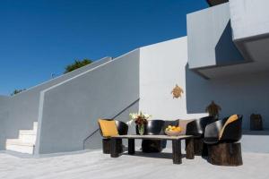 a living room with a table and chairs at Mary Luxury House in Émbonas