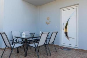 a dining room with a black table and chairs at Mary Luxury House in Émbonas