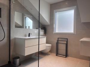 a bathroom with a sink and a toilet at Angel Services - Le Vivier in Talloires