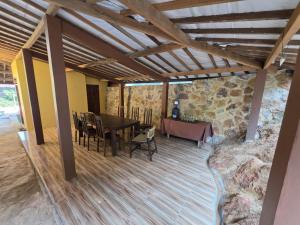 a dining room with a table and a stone wall at Popeye Karimunjawa in Karimunjawa