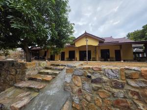 a stone wall in front of a building at Popeye Karimunjawa in Karimunjawa