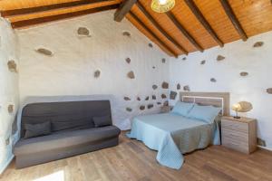 a bedroom with a bed and a couch at Palmeral de Taidía in Taidía +124 photos